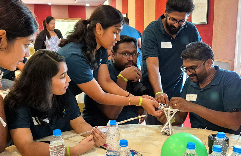 Participants working together in a hands-on team-building activity